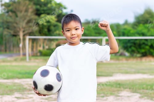 Preview: Portrait of child boy playing a football.