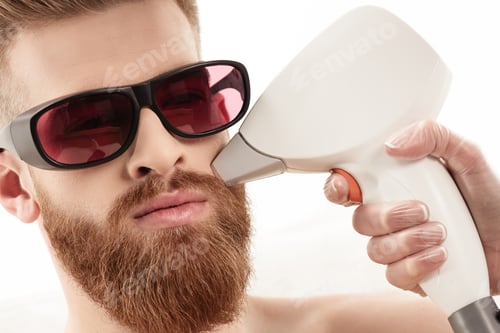 Preview: young man receiving laser skin care on face isolated on white. healthy lifestyle man concept