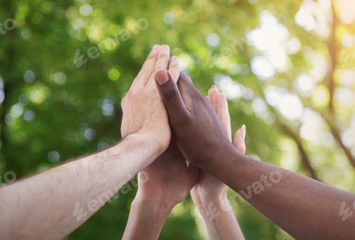 Preview: Business team giving group high five in park
