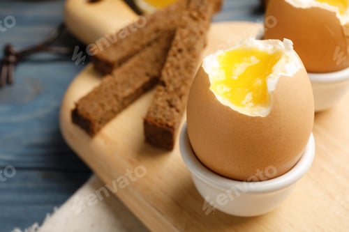 Preview: Holder with soft boiled egg on table. Space for text