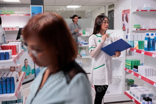 Preview: Asian healthcare specalist checking medicaments stock