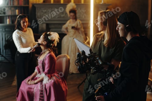 Preview: Young Caucasian Woman Getting Makeup Applied during Baroque Film Production