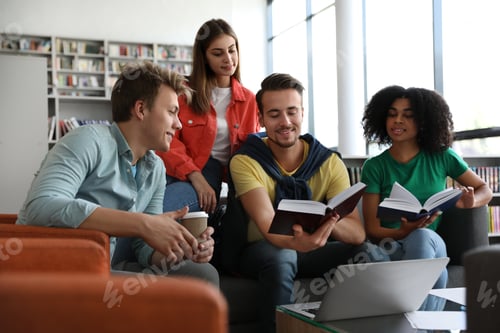 Preview: Group of young people studying at table in library