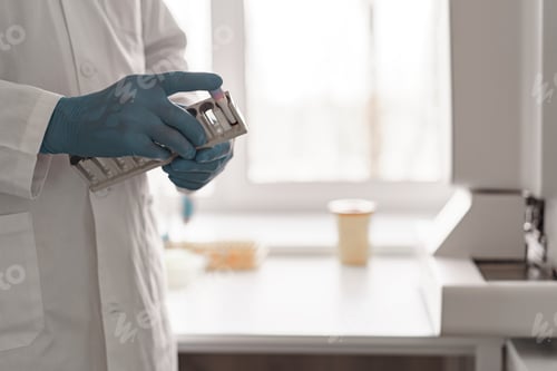 Preview: Close up of scientist hands is holding test tubes at laboratory. Medicine and research in chemistry