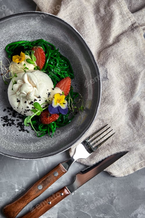 Preview: Burrata salad with strawberries and seaweed, on a gray background. Salad with buratta cheese on a