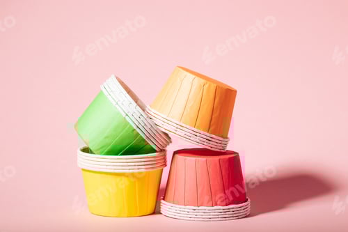 Preview: Colorful Cupcake Liners Stacked on a Pink Background