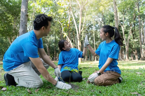 Preview: Family volunteers planting trees and celebrating environmental conservation efforts together