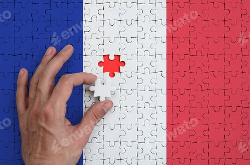 Preview: France flag is depicted on a puzzle, which the man's hand completes to fold.