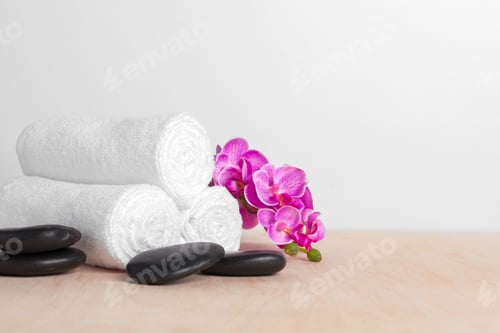 Preview: clean soft towels with flower on wooden table