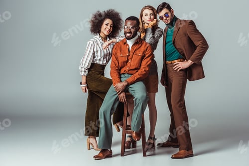 Preview: smiling multicultural retro styled friends looking at camera on grey