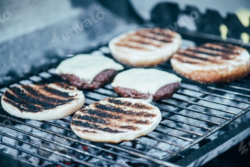 Preview: selective focus of delicious fresh burgers ingredients with crust grilling on barbecue grid