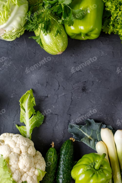 Preview: Border of green raw vegetables on black background. Top view of healthy organic food. Copy space