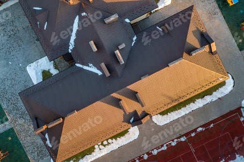 Preview: Top aerial view of building brown shingle tiled roof with complex configuration construction.
