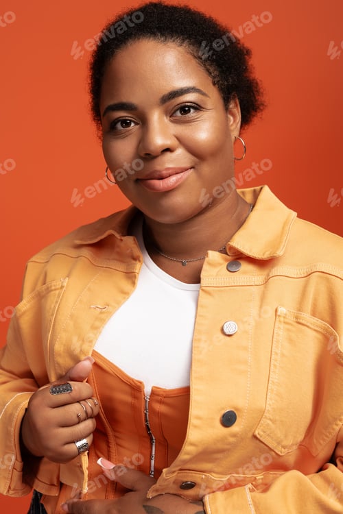 Preview: Stylish plus size woman showcases trendy autumn fashion in vibrant studio setting