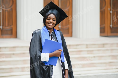 Preview: African American graduate holding diploma.