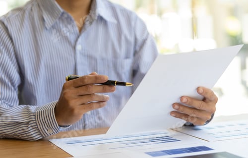 Preview: Business people working with financial documents analyzing business financial data.