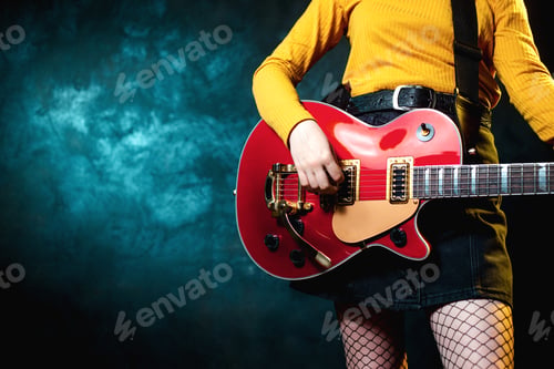 Preview: Close-up photo of young hipster woman legs and red guitar in neon lights.