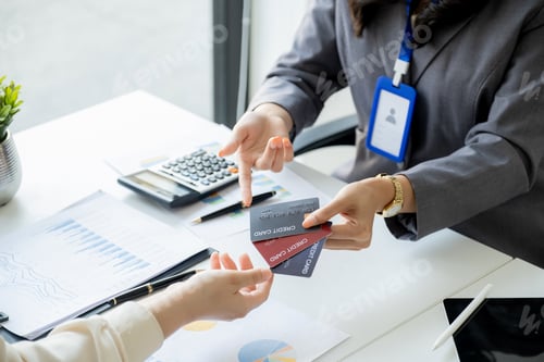 Preview: Employees present with mock up credit card payments to business customers. Ready to provide discount