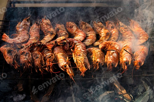 Preview: Cooking sea delicacies langoustines on the grill, on the fire