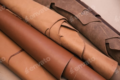 Preview: Array of leather fabric samples in different shades neatly placed on a table, ready to be crafted