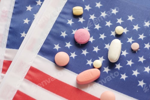Preview: white color medical pills spilling on american flag