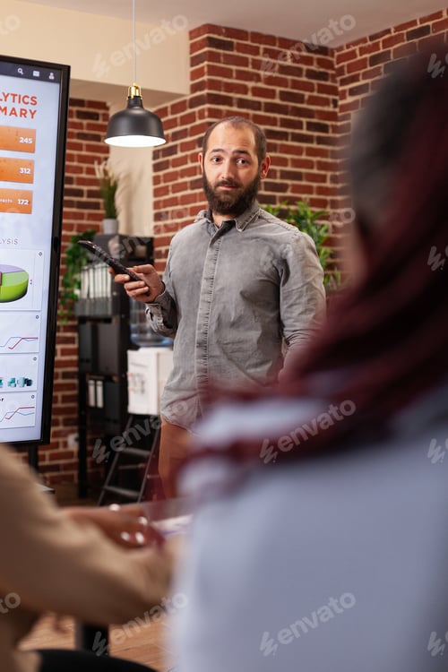 Preview: Entrepreneur man pointing at monitor explaining management statistics