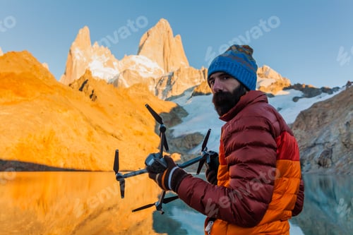 Preview: Tourist with drone on a background of mountain landscape. Patagonia