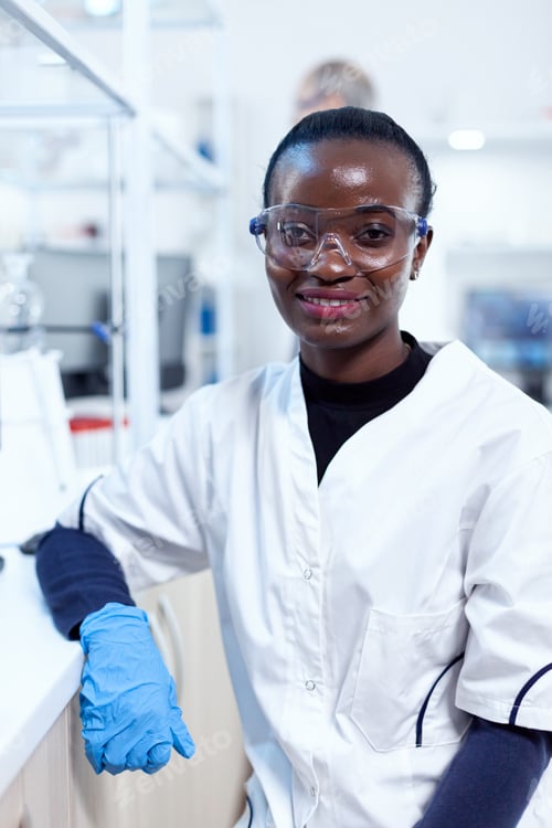 Preview: African scientist wearing protective glasses in medical laboratory