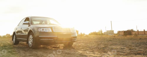 Preview: Black sedan car against sunlight, space for text
