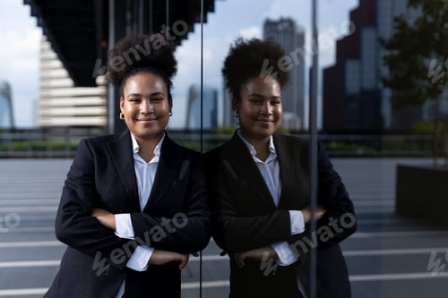 Preview: Successful young businesswoman african american black suit crossed arms smiling looking at camera