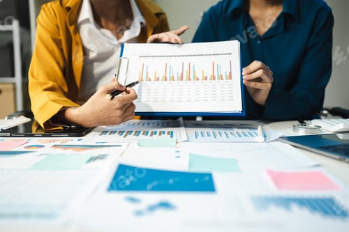 Preview: financial asian advisor showing plan of investment to clients in the consultancy office.