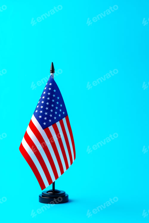 Preview: Small flag of USA on flagpole on studio background