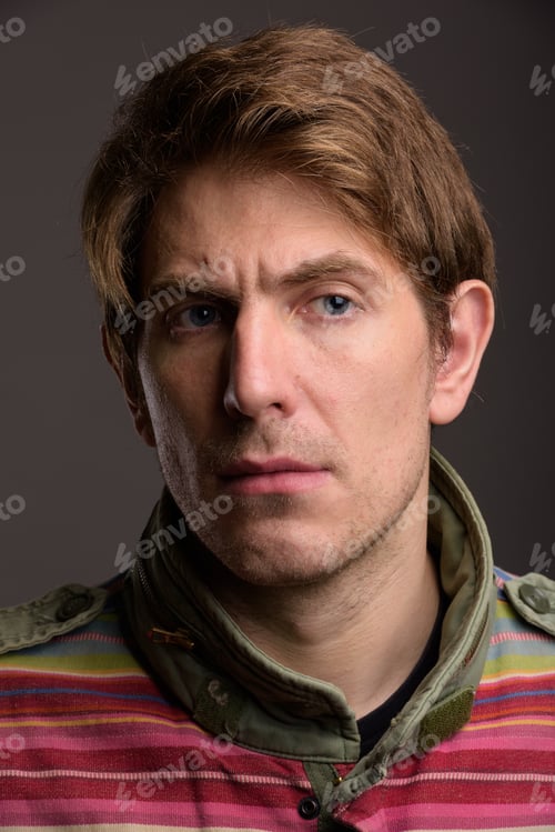 Preview: Portrait of handsome man against gray background