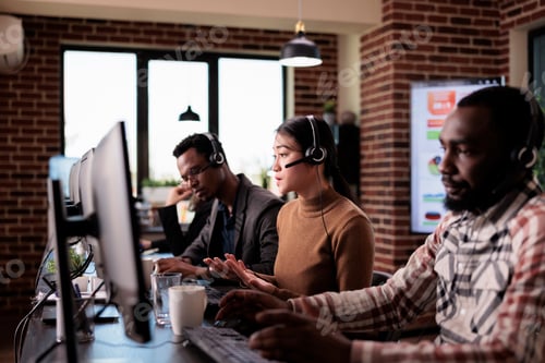 Preview: Operator working at call center with multiethnic group of people