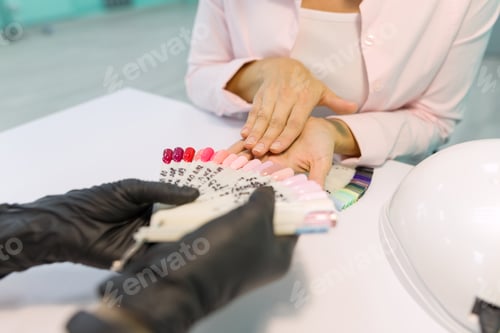 Preview: Woman Choosing Nail Polish Colors at Salon