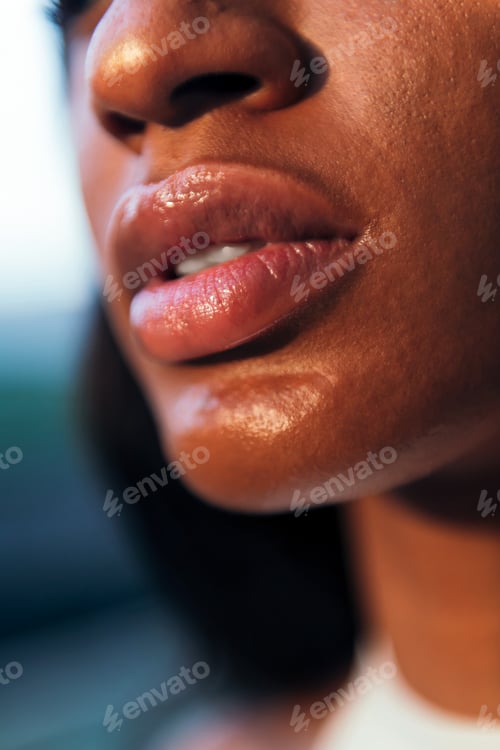 Preview: detail of full-lipped mouth of an african woman