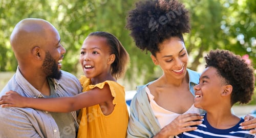 Preview: Portrait Of Smiling Family Standing In Summer Garden Or Countryside Smiling At Camera