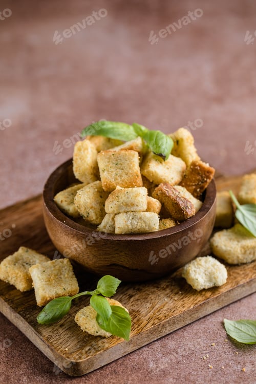 Preview: Homemade slices of diced Salty croutons on cutting board. Crackers for food.