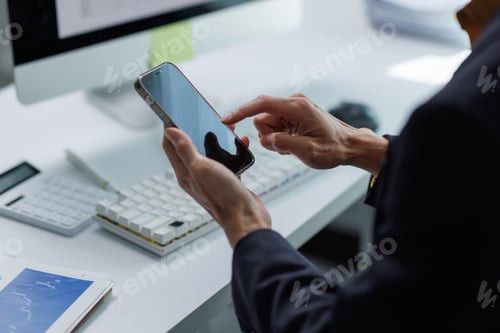 Preview: Business professional using smartphone for mobile communication