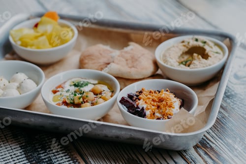 Preview: Food and nutrition concept. Traditional Israel dish for dinner. Tray of delicious hummus