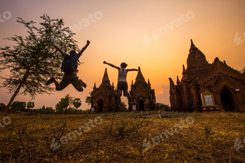 Preview: A young tourist looking at the sun on a sunset from a temple in Bagan. Myanmar