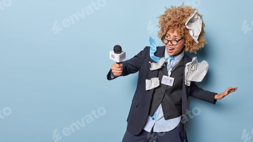 Preview: Scared emotional female journalist ready to broadcast holds microphone wears formal clothes screams
