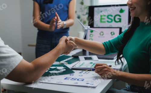 Preview: Business people shaking hands over esg environmental agreement
