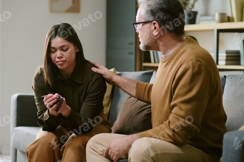 Preview: Middle Aged Man Comforting Young Adult Woman during Counseling