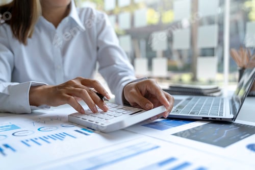 Preview: Close up Businessman using calculator and laptop for calaulating finance, tax, accounting, statistic