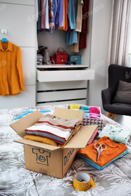 Preview: T-shirts and delivery box on the bed