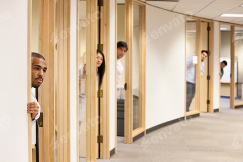 Preview: Individual business people looking out the doorway of their offices.