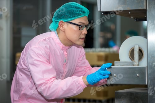 Preview: Worker Checking quality or checking stock of glass bottle in beverage factory.