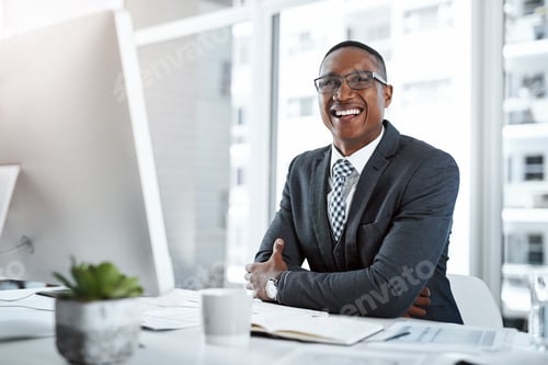 Preview: Portrait of a young businessman working at his desk in a modern office