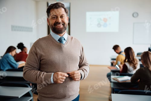 Preview: Happy teacher in lecture hall at the university looking at camera.